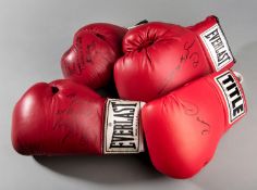 A group of four boxing gloves signed by Oscar De La Hoya, Sugar Ray Leonard,