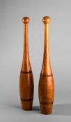 A pair of vintage gymnasium polished wooden Indian clubs circa 1900, each weighing 1lb 8oz.