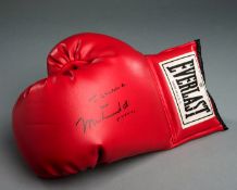 A boxing glove signed by Muhammad Ali and with a presentation inscription to the movie actor Sir