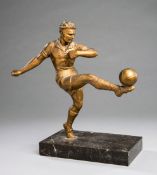 Spelter figure of a footballer, gilt-bronze patina, modelled striking a right-foot volley,