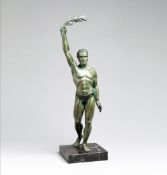 "Le Vainqueur", a spelter figure of a classical athlete holding aloft laurel, green patina,