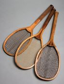 Three early 20th century wooden framed lawn tennis racquets, all with a convex head,