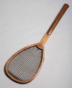 A tilt-top tennis racket stamped 'Chas.