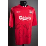 A red Liverpool replica jersey signed by the 2005 Champions League winners,