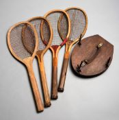 Four 1920s wooden tennis racquets, all with a convex wedge,