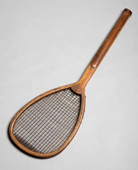 A tilt-top tennis racket stamped 'Chas.
