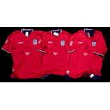 A trio of red England v Argentina 2002 World Cup replica jerseys signed by David Beckham,