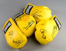 A group of four autographed yellow Lonsdale boxing gloves,