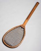 A tilt-top tennis racket stamped 'Chas.