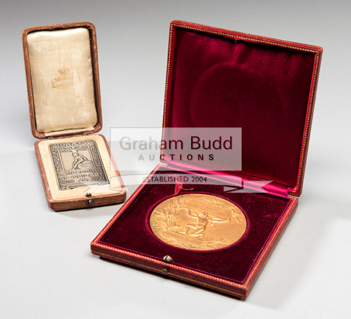 Two cased prize medals for continental tennis tournaments, the first in gilt-bronze by Henri Dubois,
