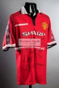 A multi-signed Manchester United 1999 Treble Winners jersey,