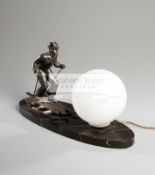 A continental Art Deco period table lamp featuring a skier, the silvered figure signed L.