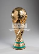 A full-size replica of the FIFA World Cup trophy, height 35cm., extremely heavy weighing some 4kg.