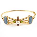 Yellow gold opal, pearl, ruby and peridot bangle.