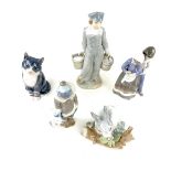 A group of five porcelain figurines.