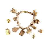 Yellow metal charm bracelet, tests 9 ct gold.