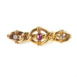 15 ct yellow gold ruby and diamond brooch. Set with two old cut diamonds and an oval cut ruby.