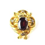 Yellow gold garnet and pearl mourning brooch. The central oval cut garnet measuring 12.5 x 9.