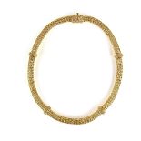 Yellow gold tubular necklace. The mesh links forming a hollow tube set with solid gold spacers.