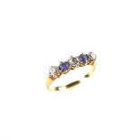 Yellow gold sapphire and diamond five stone ring.