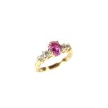 14 ct yellow gold pink sapphire and diamond ring. The oval cut pink sapphire weighing approx. 0.