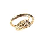 9 ct yellow gold serpent bangle. Designed as a coiled snake with ruby eyes. Weight 13.3 grams.