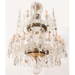 Crystal chandelier with thirty arms and with faceted drops.