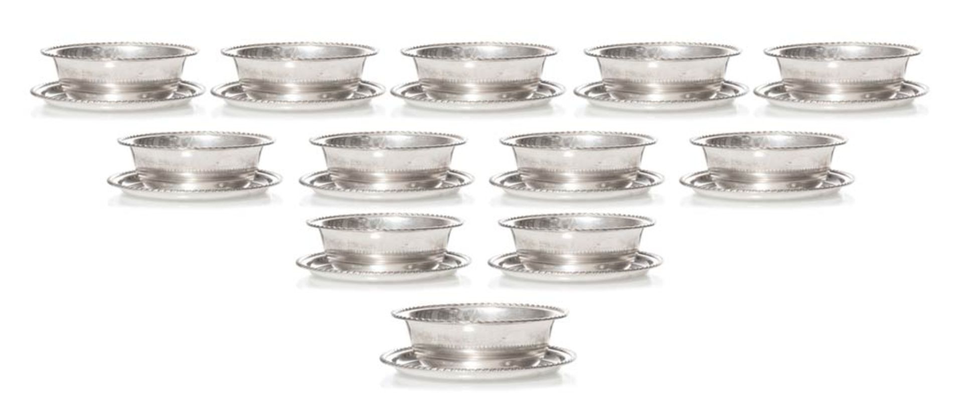 Set of twelve silver bowls and twelve silver dishes.