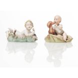 Capodimonte, Coppia statuine in porcellana policroma, "Bambini su cuscino", XX sec.