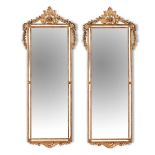 Pair of carved and gilt wood mirrors, 20th Century.