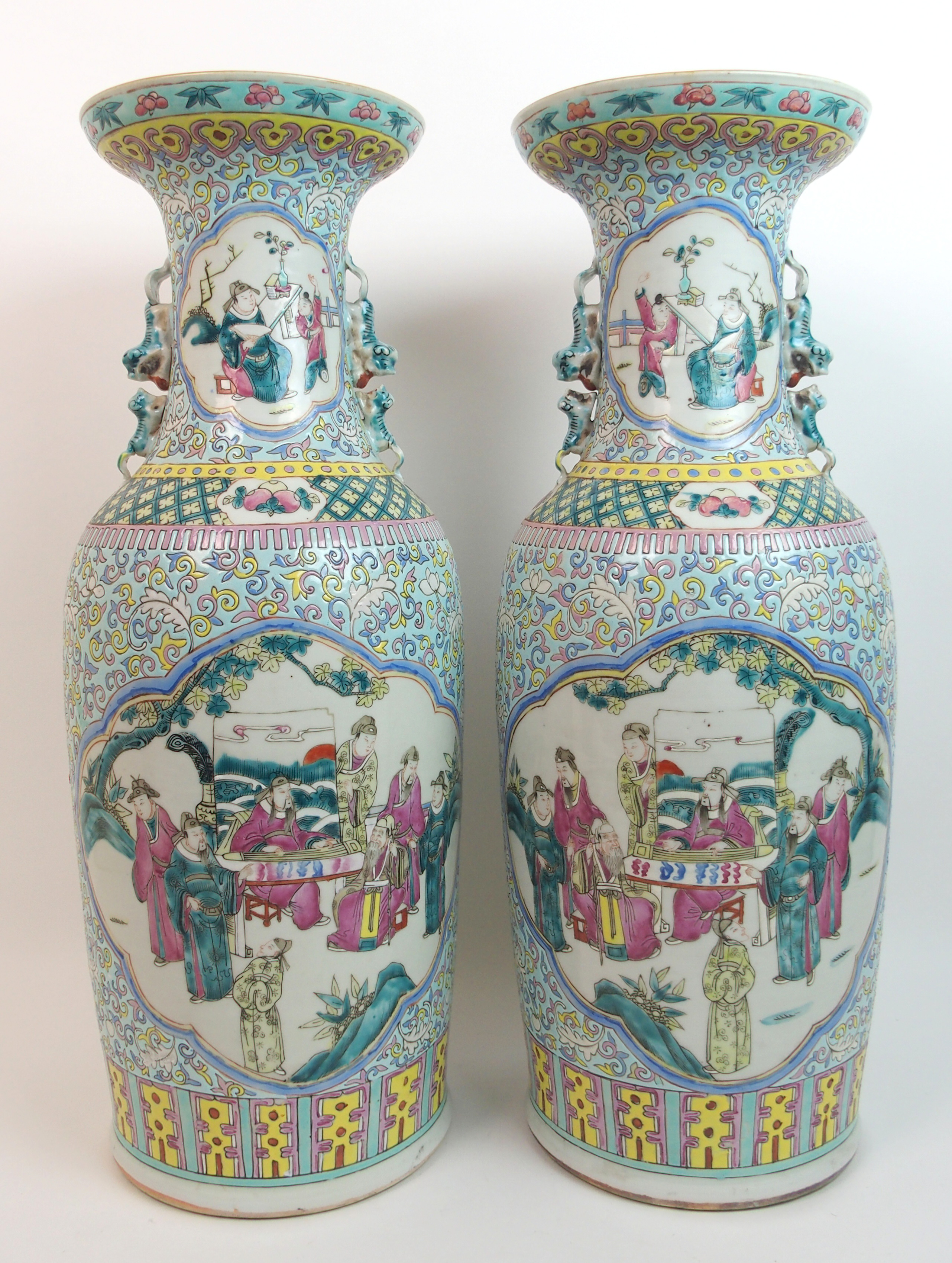 A large pair of Cantonese famille verte baluster vases painted with panels of sages and