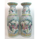 A large pair of Cantonese famille verte baluster vases painted with panels of sages and