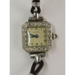 A yellow and white metal diamond set cocktail watch the square dial with black Arabic numerals and