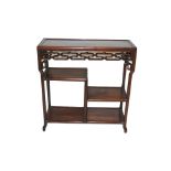 A Chinese hardwood rectangular open display stand with pierced scroll frieze above three shelves