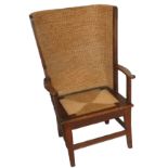 An Orkney gent's armchair in oak with straw-work back, lift-out seat, scroll arms and on square