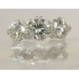 A substantial three stone diamond ring estimated approximate total of 2.78cts, in decorative