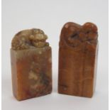 A Chinese soapstone seal carved with a feline 5.8cm high and another with a buddhistic lion and