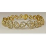 An 18ct gold diamond bracelet of spiral forms set with approximately 3.90cts of brilliant cut