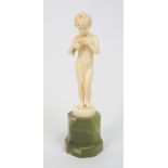 A Ferdinand Preiss (German 1882-1943) Fishing Boy carved ivory figure, signed F Preiss, upon an onyx