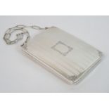 A sterling silver card/sovereign case of rectangular form with engine turned decoration, floral