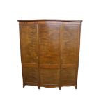 A mahogany bedroom suite comprising; three door wardrobe, dressing table with pull-out mirror