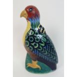 Elizabeth Mary Watt (1886-1954) A pottery figure of a parrot painted in shades of blue, green, red