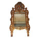 An Italian giltwood wall mirror carved with a vase of flowers and fruit above scrolling foliate