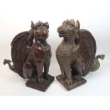 Two Victorian oak carved griffins with grotesque features, 47cm high (2)