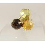 A 14ct gold citrine and quartz dress ring set with three checkerboard cut gemstones two citrines