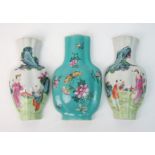 A pair of Canton famille rose vase shaped wall plaques painted with figures in gardens, 16cm high