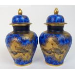 A pair of Carlton Ware Paradise Bird and Tree pattern jars and covers each decorated with swallows