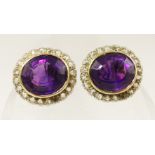 A pair of substantial 9ct gold amethyst and diamond earrings the oval mixed cut amethysts of