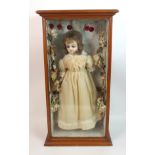 An early wax over doll in period dress in decorated glass display case, doll approx 60cm (23.1/2")