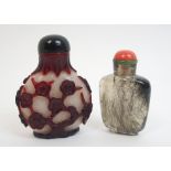 A Chinese red and carved overlaid glass snuff bottle and stopper with stiff leaf neck pattern